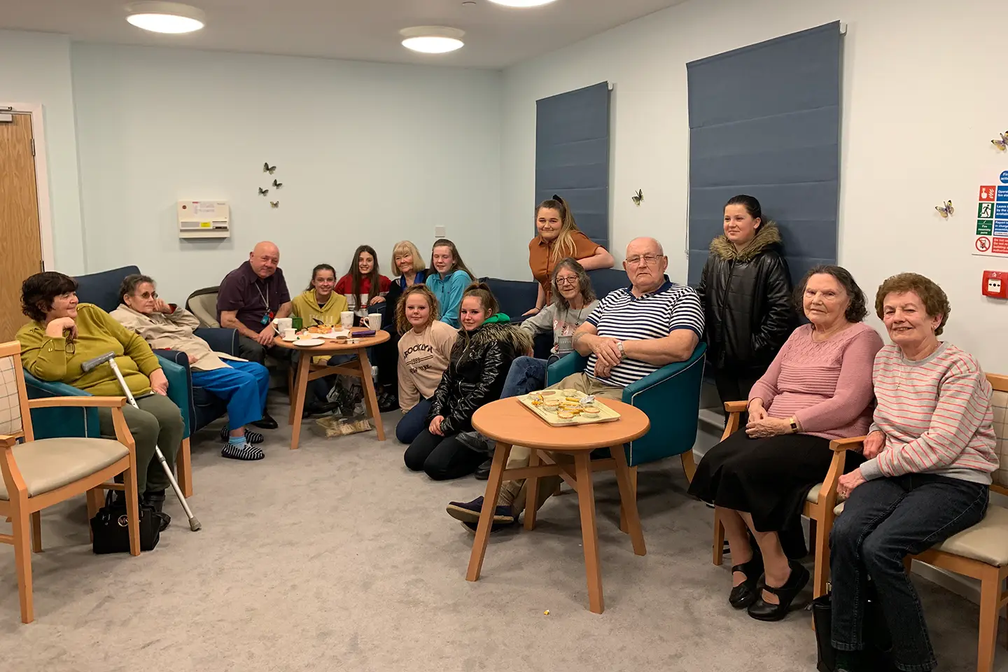 A diverse, happy group of people attending a community theatre production.